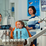 a little girl is getting dental treatment