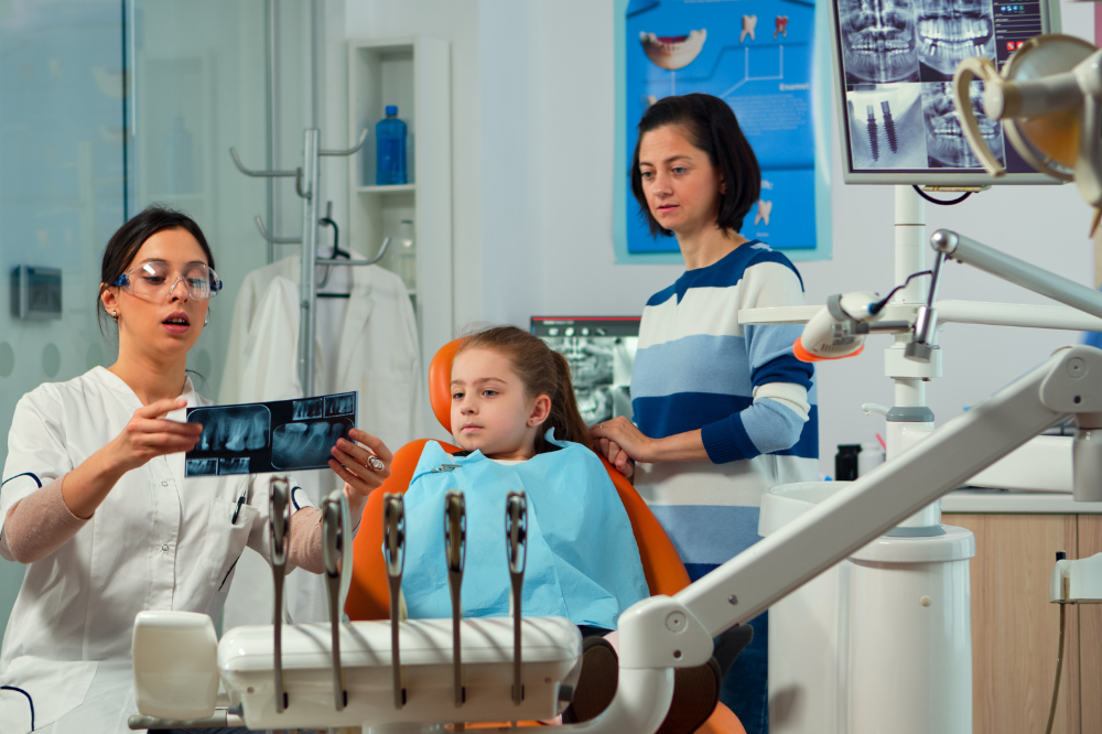 a little girl is getting dental treatment